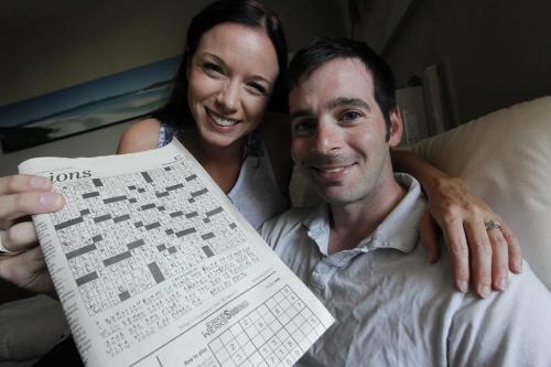 July 1, 2012 - 120701  -  In their home Sunday July 1, 2012 Rachael Hatherell and Daniel Minuk show off the Cryptoquip puzzle in the June 30th edition of the Winnipeg Free Press in which Minuk hid his clever wedding proposal to Hatherell.    John Woods / Winnipeg Free Press