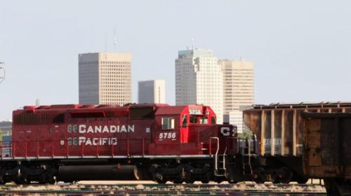 A CP train engine passes along the tracks at the CP Rail Yards With downtown Winnipeg in the background.  See Mary Agnes Welch story 120703 July 03, 2012 Still image from video Mike Deal / Winnipeg Free Press