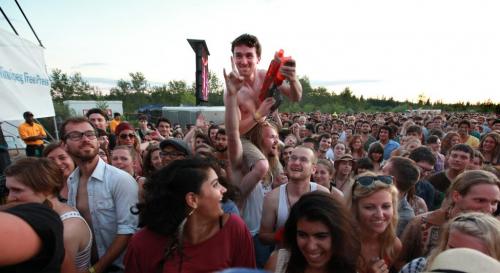 Dylan Maxwell sprays people in the crowd with water with his water gun while on his friend Don Loewen's shoulders while Feist performs on the Main Stage at the 39th annual Winnipeg Folk Festival at Birds Hill Park Wednesday night.  July 04,  2012 (Ruth Bonneville/Winnipeg Free Press)