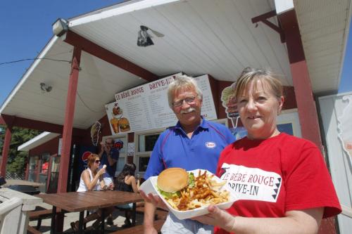 Le Bébé Rouge near St. Pierre-Jolys. Owners Donat and Elaine Mellor pose with their awesome burger and fries. It's on Highway 75 south. July 5, 2012  BORIS MINKEVICH / WINNIPEG FREE PRESS