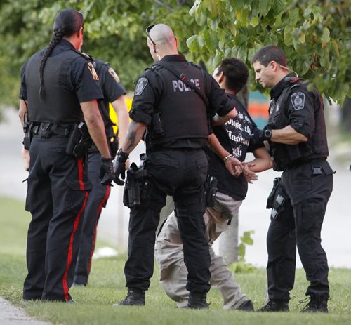 Winnipeg Police and the Tactical Support Unit take a man into custody on Granite Way around 9:45pm, Friday, July 6, 2012. (TREVOR HAGAN/WINNIPEG FREE PRESS)