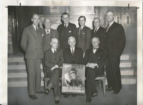 Winnipeg Free Press Archives
Winnipeg WWII Home Front
January 27, 1941
Life is a whirlwind at provincial war savings committee headquarters, 35G Main Srreet, these days, as zero hour for the big war savings certificates push looms nearer. Pictured above are the chairmen and vice-chairmen of the various main committees who are busily laying plans that will enable 130,000 patriotic Manitobans to save monthly through war savings certificates. Seated on the bench, from left to right, are Peter Lowe, vice-chairman of the provincial committee and chairman of the employer-employee committee; B. J. Tarr. provincial chairman, and G. F. Pearson, chairman of the Manitoba committee. Standing, from left to right, are E. S. Chard, secretary; B. G. Carnegie, a vice-chairman of the Greater Winnipeg enrolment committee; Patrick Gyles, vice-chairman of the Greater Winnipeg co'ramittee; Wilfred Womersley, manager of the enrolment committee and publicity chairman of the Greater Winnipeg committee; Paul DuVal, chairman of the enrolment committee, and Dr. H. B. Sommcrfeld. chief organizer of the Manitoba committee. 'Missing from the picture are C. E. Graham, vice-chairman of. the Manitoba committee; D. R. Ferguson, former chairman of the employer-employee committee; C. F. Gray, director for Manitoba, employer-employee committee; W. T. Gwyn, a vice-chairman of the provincial committee; Cecil Lament, chairman of the publicity committee;,1- Stanley N. Jones, vice-chairman of the enrolment committee, and E. G. Persse, chairman of the Greater Winnipeg committee.
