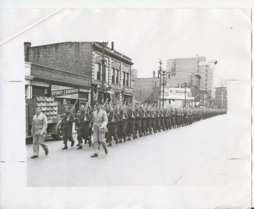 Winnipeg Free Press Archives
Winnipeg WWII Home Front
September 23, 1940
Soldiers salute the Red Cross Helping the Canadian Red Cross society in its urgent appeal for $5,000,000 to carry on its essential work, some 500 soldiers stationed at the infantry training centre. Fort Osborne barracks, paraded through downtown Winnipeg, Monday. Here a detachment is shown marching along Portage Avenue.
