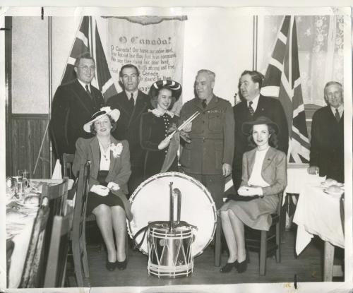 Winnipeg Free Press Archives
Winnipeg WWII Home Front
May 16, 1941
Drums For the Troops These bugles and drums will soon keep the beat in martial time for a unit of the Canadian army. They were presented to Military District No. 10 by the St. Boniface Kiwanis club at a luncheon, meeting, Thursday, at, the Nicolett  hotel. In the presentation pictured above are: Left to right, back row, Trafford Taylor, J. H. Mooradian, president of the club: Gladys Forrester, of the club's Thumbs Up revue; Lt.-Col. James Neish, who accepted the instruments presented by Mayor George MacLean, right. Front row, left to right, Dorothy Johnston and Ruth King, of the Thumbs Up revue.