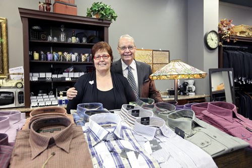 Brandon Sun 13072012 Gwen and Brian Bromley, owners of the Cinnamon Tree and Bromley's Mens Wear respectively, pose for a photo in the Bromley's section of the storefront they now share at 934 Rosser Ave. on Friday. (Tim Smith/Brandon Sun)