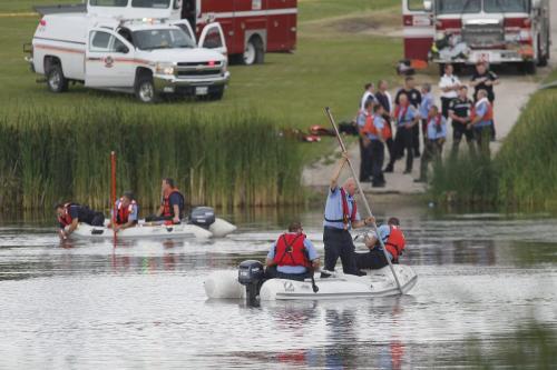 July 16, 2012 - 120716  - Firefighters search for a missing person in a retention pond just north west of Burrows Avenue and Albina Way Monday, July 16, 2012.  John Woods / Winnipeg Free Press
