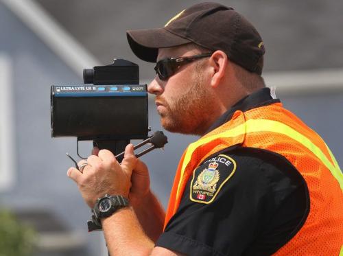A Winnipeg Police officer uses a laser speed gun to catch speeding Winnipegers coming down the Northbound hump of the Slaw Rebchuk bridge Tuesday- July17, 2012   (JOE BRYKSA / WINNIPEG FREE PRESS)