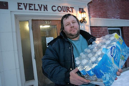 BORIS MINKEVICH / WINNIPEG FREE PRESS  070225 Jean Chabauty is a resident of 951 Westminister Ave. and is not happy that the apartment block he lives in had a sewer problem. The landlord has brought in cases of water for the residents. He holds one of those cases in the photos. He said that it is time for the City of Winnipeg to step up and fix the problem. He also said that he thinks that there should at least be a few portable toilets outside for residents to go to the bathroom.