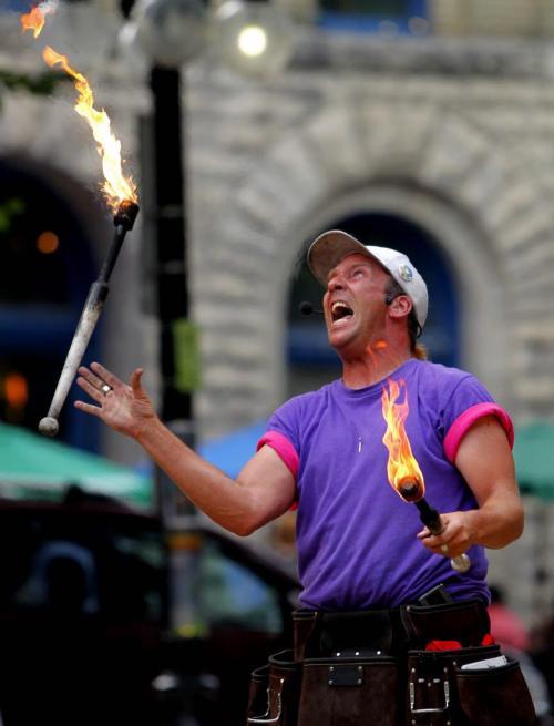 Fringe at Old Market Square - Chris Without the Hat juggles fire for the crowds. July 18, 2012  BORIS MINKEVICH / WINNIPEG FREE PRESS