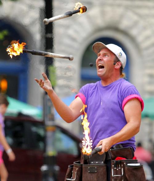 Fringe at Old Market Square - Chris Without the Hat juggles fire for the crowds. July 18, 2012  BORIS MINKEVICH / WINNIPEG FREE PRESS