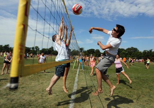 Andrew Hildebrand, right, from Dig This, hits the ball during the Super-Spike Volleyball Tournament at Maple Grove Rugby Park, Saturday, July 21, 2012. (TREVOR HAGAN/WINNIPEG FREE PRESS)