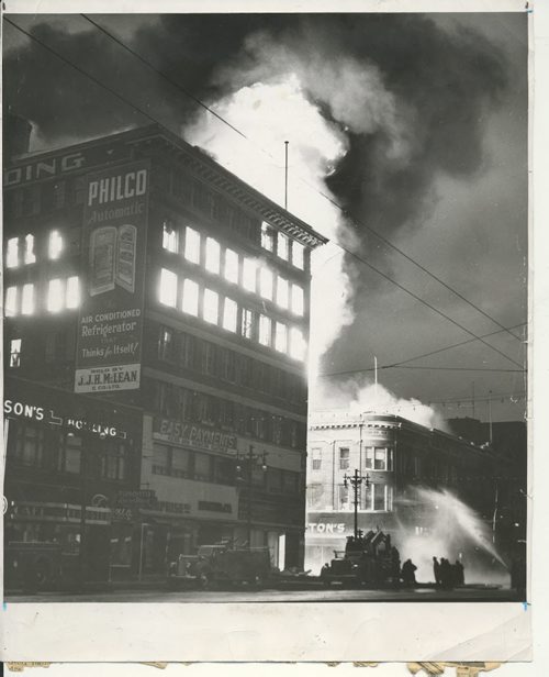 Jack Ablett/Winnipeg Free Press Archives Time Building Fire  (07) June 8, 1954 Flames Race With Lightening Speed To Additional Targets  Fire has caught the Dismorr block, housing Dayton's store, and firemen pour on water in efforts to check the blaze. fparchive
