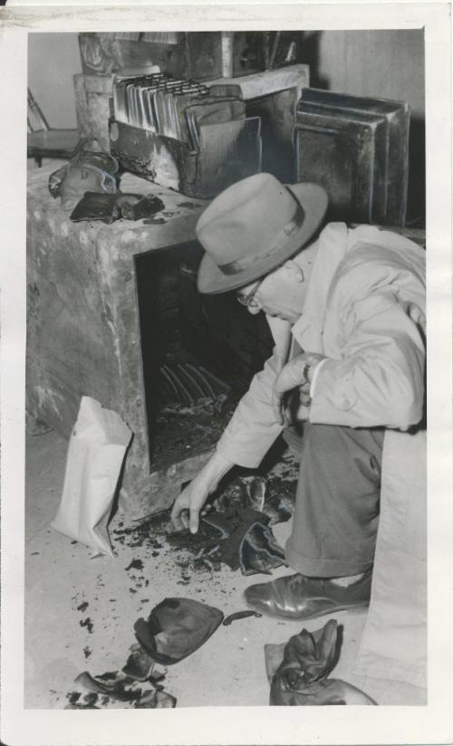 Winnipeg Free Press Archives Time Building Fire  (11) June 10, 1954 Two steel safes were salvaged Wednesday from the smouldering ruins of Dayton's Ltd., on the corner of Portage avenue and Hargrave street. In this picture, R. E. Coddington of the National Cash Register examines some of the charred paper money and blackened coins removed from one of the safes. fparchive