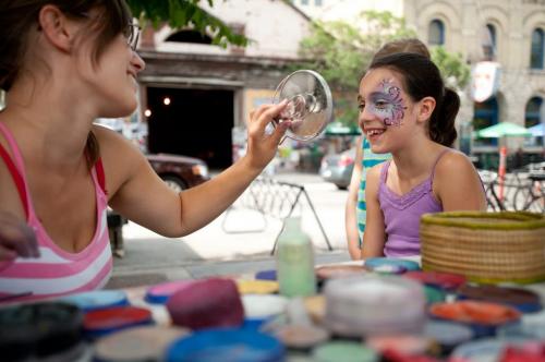 120724 Winnipeg - Morgan McShane looks at her freshly painted face for the first time at the Winnipeg Fringe Theatre Festival. The artist Carolyn Zacharias has been face painting at the festival for the past decade, since she was 13 years old.  July 24 2012. COLE BREILAND / WINNIPEG FREE PRESS