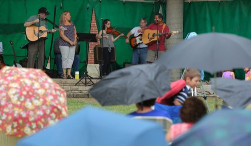 Brandon Sun Larry Roulette, right, performs on stage with his friends during Tuesday's Music in the Park at Princess Park. (Bruce Bumstead/Brandon Sun)