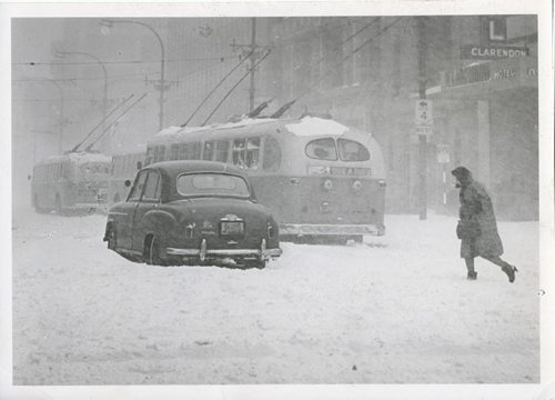 Jack Ablett/Winnipeg Free Press Archives Winnipeg Blizzard (8) March 5, 1966 A car sits trapped right In the middle of Portage Avenue. fparchive