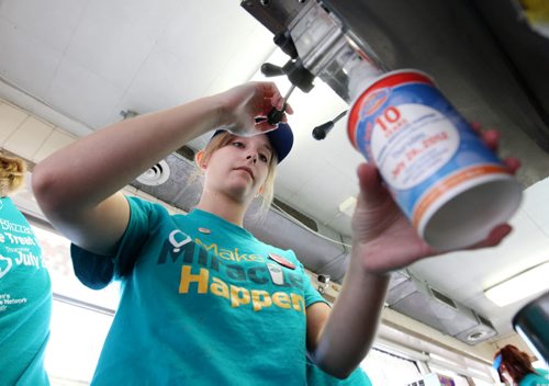 Brandon Sun 26072012 18th St. Dairy Queen employee Anja Hamilton makes a Blizzard during DQ Miracle Treat Day on Thursday afternoon. One dollar from every Blizzard sold yesterday will go to the Children's Hospital Foundation of Manitoba. (Tim Smith/Brandon Sun)