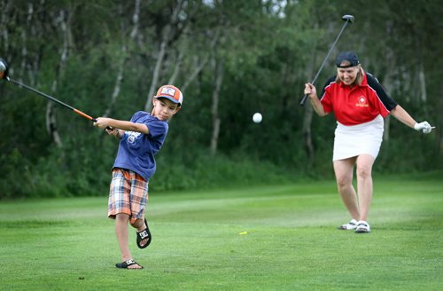 Brandon Sun Dwayne Oman tees off with close family friend Roz Evason during a charity golf tournament, Saturday afternoon at the Shilo Golf and Country Club. The tournament, held in honour of Roz' late husband Dan (popularly known as "Heavy"), raised tens of thousands of dollars for the Special Olympics and is the final one to be held in his memory. (Colin Corneau/Brandon Sun)