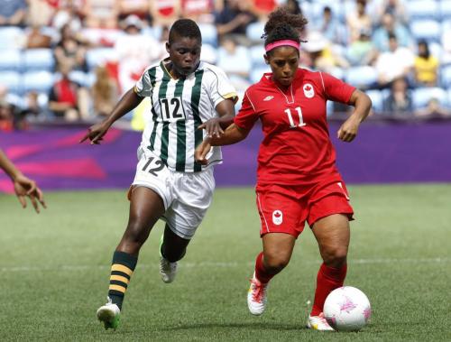 South Africa's Portia Modise (L) fights for the ball with Canada's Desiree Scott during their women's Group F football match at the London 2012 Olympic Games in the City of Coventry Stadium July 28, 2012. REUTERS/Alessandro Garofalo (BRITAIN  - Tags: SPORT SOCCER SPORT OLYMPICS)