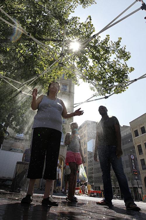 July 29, 2012 - 120729  -  Fringers cool off in the mister at Market Square while they take in the last day of the Winnipeg Fringe Festival in Winnipeg Sunday July 29, 2012.    John Woods / Winnipeg Free Press