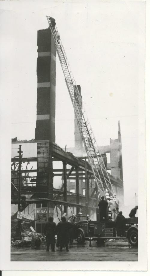 /Winnipeg Free Press Archives Time Building Fire (18) June 9, 1954  On the left, workmen from  R. Litz and Sons.  moved away. The ariel ladder has moved away. A brief  moment later the pillar toppled and crumbled. fparchive