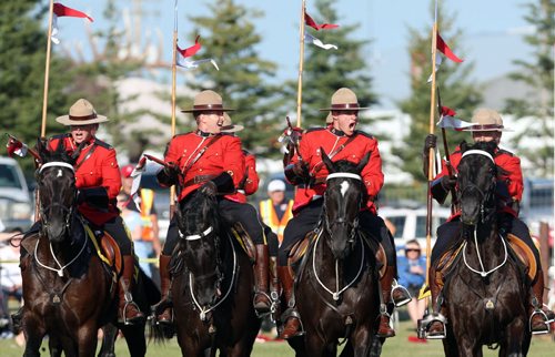 Brandon Sun Members of the RCMP Musical Ride perform their famous "charging" maneuver during a show in Onanole, Sunday evening. Proceeds from the show benefitted local charities, including a new play structure for the town's elementary school. The horses and riders will be stabling in Onanole until Wednesday morning before setting out to a show in McCreary. (Colin Corneau/Brandon Sun)