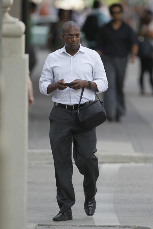 July 30, 2012 - 120730  -  Texters walk down Portage Avenue at Smith and text as they go Monday July 30, 2012.    John Woods / Winnipeg Free Press