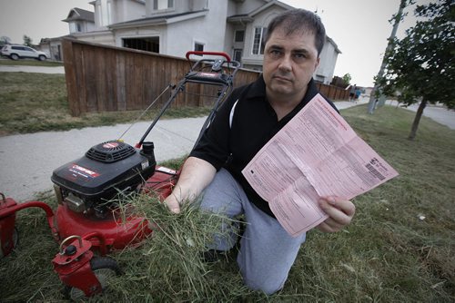 August 1, 2012 - 120801  -  Richard Hykawy has been charged by the city and is being taken to provincial court for not cutting the grass on city property that runs adjacent to his home Wednesday August 1, 2012. The city came out today and cut the grass.  John Woods / Winnipeg Free Press