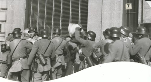 Winnipeg Free Press Archives If Day - World War II - (15) Feb. 19, 1942 Nazi Storm Troopers Demonstrate Invasion Tactics Surrounding him, they tear up his papers and scatter them on the street.  fparchive