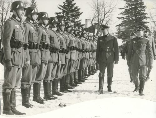 Winnipeg Free Press Archives If Day - World War II - (17) Feb. 19, 1942 Nazi Storm Troopers Demonstrate Invasion Tactics Premier Bracken, Hon. Errick Wills and other members of the cabinet and civic officials on their way to cells at Lower Fort Garry. fparchive