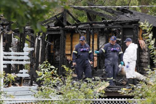 August 5, 2012 - 120805  -  Investigators inspect the charred shell of a Prospect Street home in Winnipeg Beach where two people died and one was sent to a Winnipeg hospital early Sunday morning August 5, 2012.    John Woods / Winnipeg Free Press