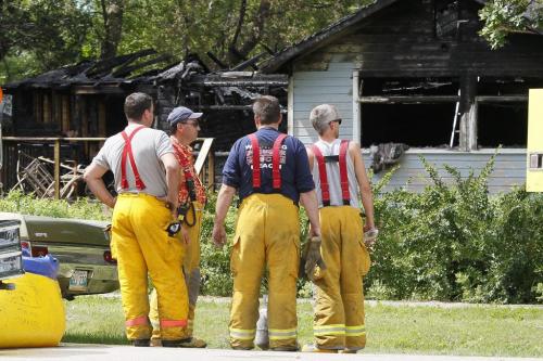 August 5, 2012 - 120805  -  Winnipeg Beach firefighters look at the charred shell of a Prospect Street home in Winnipeg Beach where two people died and one was sent to a Winnipeg hospital early Sunday morning August 5, 2012.    John Woods / Winnipeg Free Press