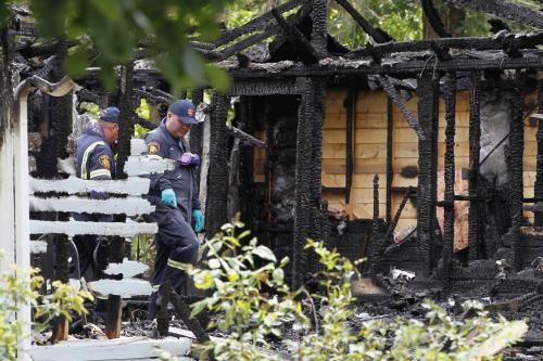 August 5, 2012 - 120805  -  Investigators inspect the charred shell of a Prospect Street home in Winnipeg Beach where two people died and one was sent to a Winnipeg hospital early Sunday morning August 5, 2012.    John Woods / Winnipeg Free Press
