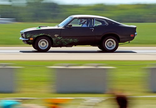 Brandon Sun One of 53 entrants in the drag racing competition speeds past spectators during the 12th annual Yellowhead Roadrunners Auto Club races, Sunday afternoon at the Neepawa Airport. Rain pushed the competition up a day, which also featured a biodisel fuelled, jet engine equipped drag racer. (Colin Corneau/Brandon Sun)