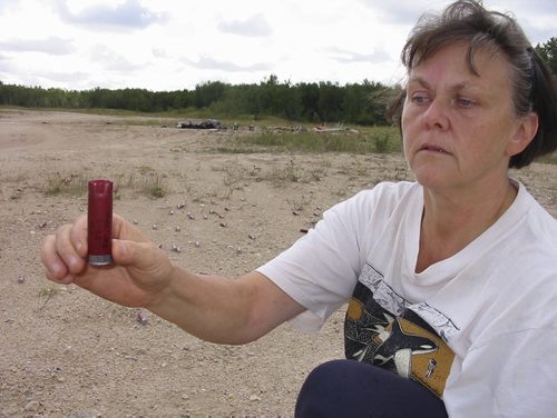 Mars Hills photos from bill redekop Winnipeg Free Press  018 - Peggy Kasuba holds up one of tens of thousands of spent shells found in Mars Hills.