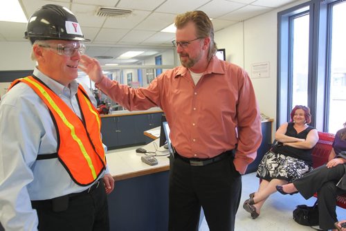 Brandon Sun Brandon Sun Managing Editor James O'Connor, right, gives Premier Greg Selinger a friendly pat on the shoulder during the Premier's visit to the Brandon YMCA construction site on Wednesday afternoon. FOR JAMES' COLUMN (Bruce Bumstead/Brandon Sun)