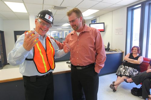 Brandon Sun Brandon Sun Managing Editor James O'Connor, right, gives Premier Greg Selinger a friendly pat on the shoulder during the Premier's visit to the Brandon YMCA construction site on Wednesday afternoon. FOR JAMES' COLUMN (Bruce Bumstead/Brandon Sun)