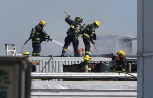 Working fire at Maple Leaf Foods at Lagimodiere Blvd and Marion  ST  , the fire is inside a building  that is part of a large complex  , fire fighters have cut through the roof to fight the fire . Fire call just after 10am Friday . KEN GIGLIOTTI  / WINNIPEG FREE PRESS  /  Aug 10 2012