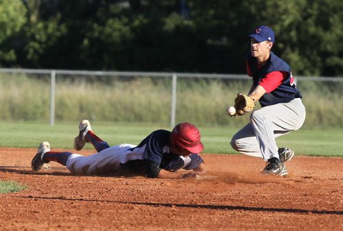 Brandon Sun Cardinals' Ty Paddock dives back to second to beat the pick-off throw to Cubs' Keith Van Walleghem during Thursday evening's senior baseball game at Brandon Field. (Bruce Bumstead/Brandon Sun)