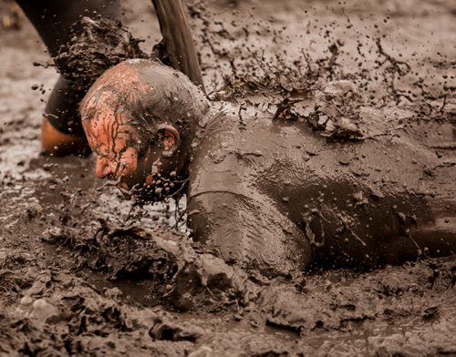 A Dirty Donkey Mud Run participant is covered in muddy water near the finish line of the Dirty Donkey Mud Run Saturday morning. The inaugural 5 kilometre obstacle run at Springhill Winter Park and Oasis Resort also offered participants the chance to raise money for the MS Society of Manitoba. 120818 - Saturday, August 18, 2012 -  Melissa Tait / Winnipeg Free Press