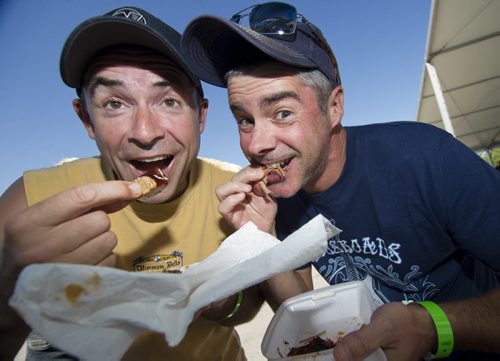 120819 Winnipeg - Wayne Friesen (left) and Marc Asselin enjoy some Ruby Red's Kansas City BBQ at the Winnipeg BBQ & Blues Festival at the Red River Ex Sunday afternoon. The winners of the BBQ competition are announced at 4pm. DAVID LIPNOWSKI / WINNIPEG FREE PRESS