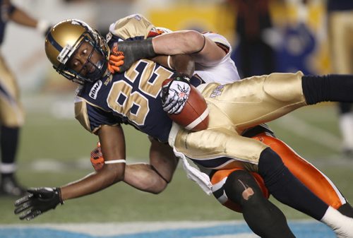 BC Lions Jason Arakgi hauls down Winnipeg Blue Bombers Terrence Edwards  during fourth quarter during CFL action at Canad Inns Stadium Friday night - BC won over the Winnipeg Blue Bombers 20-17 with 1 second left after kicking a field goal  - See Paul Wiecek story August 24, 2012   (JOE BRYKSA / WINNIPEG FREE