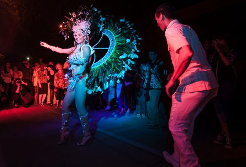 Marcia Monteggia dances in a Carnival costume with Tom Cardaso during the inaugural Carnaval Street Party on Bannatyne Avenue Saturday night.  120825 - Saturday, August 25, 2012 -  Melissa Tait / Winnipeg Free Press