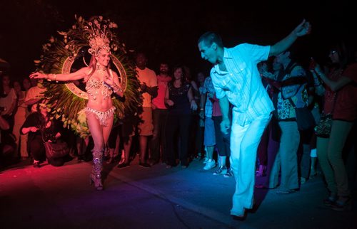 Marcia Monteggia dances in a Carnival costume with Tom Cardaso during the inaugural Carnaval Street Party on Bannatyne Avenue Saturday night.  120825 - Saturday, August 25, 2012 -  Melissa Tait / Winnipeg Free Press