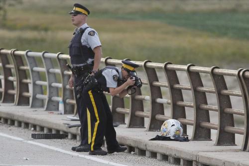 August 26, 2012 - 120826  -  RCMP officers investigate an MVC involving a RCMP cruiser and a motorcycle in the southbound lanes the north Floodway bridge on highway 59 Sunday August 26, 2012.    John Woods / Winnipeg Free Press