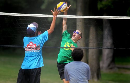 Mat Stasiuk foes up for the spike Monday afternoon at Assinaboine Park as Tyler Slobogian (in blue) and Kaleb Chartier (in grey) prepare to field it. The group of volley ball players were taking part in the St Paul's summer Sport Camp and enjoying the run of fine summer weather. See story. August 27, 2012-(Phil Hossack / Winnipeg Free Press)
