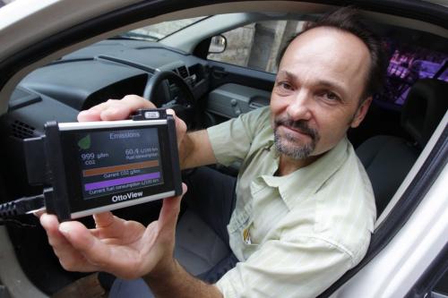 Frank Franczyk has a small electronics research fim that has just released a new device that will generate a cost gauge and data logger that, among other things, will measure how much CO2 emissions from the vehicle. Here he holds the device hooked up to the Free Press Jeep. August 28, 2012  BORIS MINKEVICH / WINNIPEG FREE PRESS