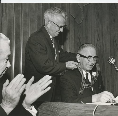 Dave Bonner/Winnipeg Free Press Archives Old City Hall (20) Oct. 6, 1964 Above left, Mayor Stephen Juba receives his chain of office (a gift from the Winnipeg Chamber of Commerce) from city clerk Thomas Mitchell. Lieutenant-Governor Errick Willis applauds.    fparchive