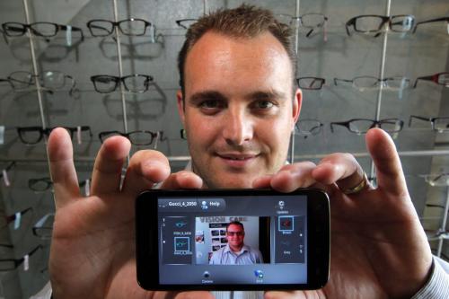 Sean Sylvestre of Eyewear Evolution holds a smart phone with app for selling eyeware online. August 29, 2012  BORIS MINKEVICH / WINNIPEG FREE PRESS