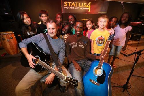 Const. Kevin Gibson and Gentil Misigaro along with a group of kids at Status4, a free music program at the East End Cultural and Leisure Centre in Elmwood, September 5, 2012. (TREVOR HAGAN/WINNIPEG FREE PRESS) - for Carol Sanders story